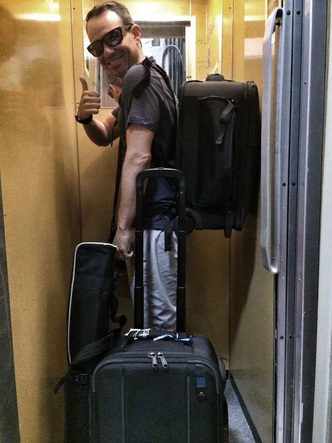 Eduardo Angel in elevator with full filmmaking gear.